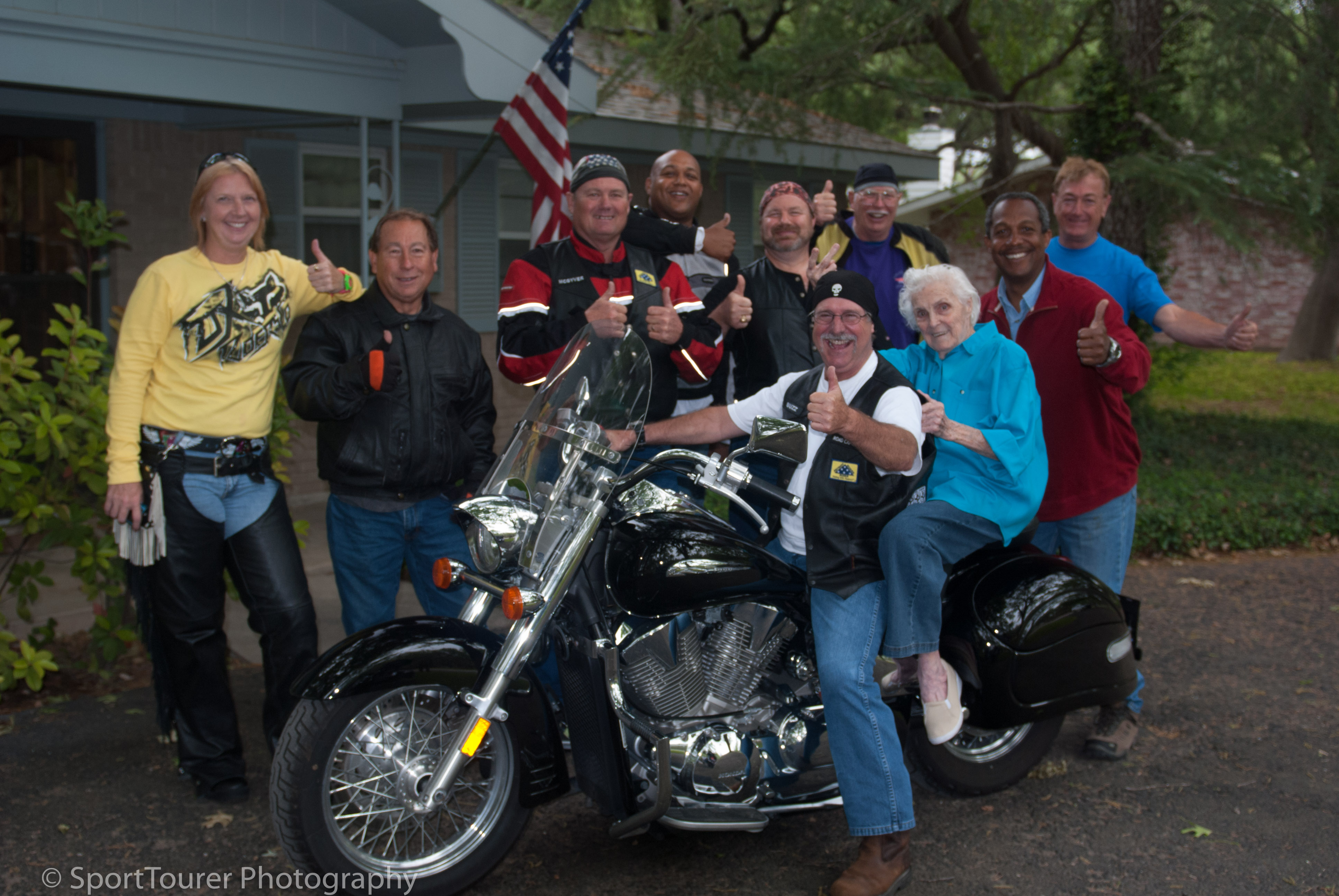  Gathering for a group photo with Grandma Esther, she initiated a thumbs up to immortalize her long-awaited bike ride. 