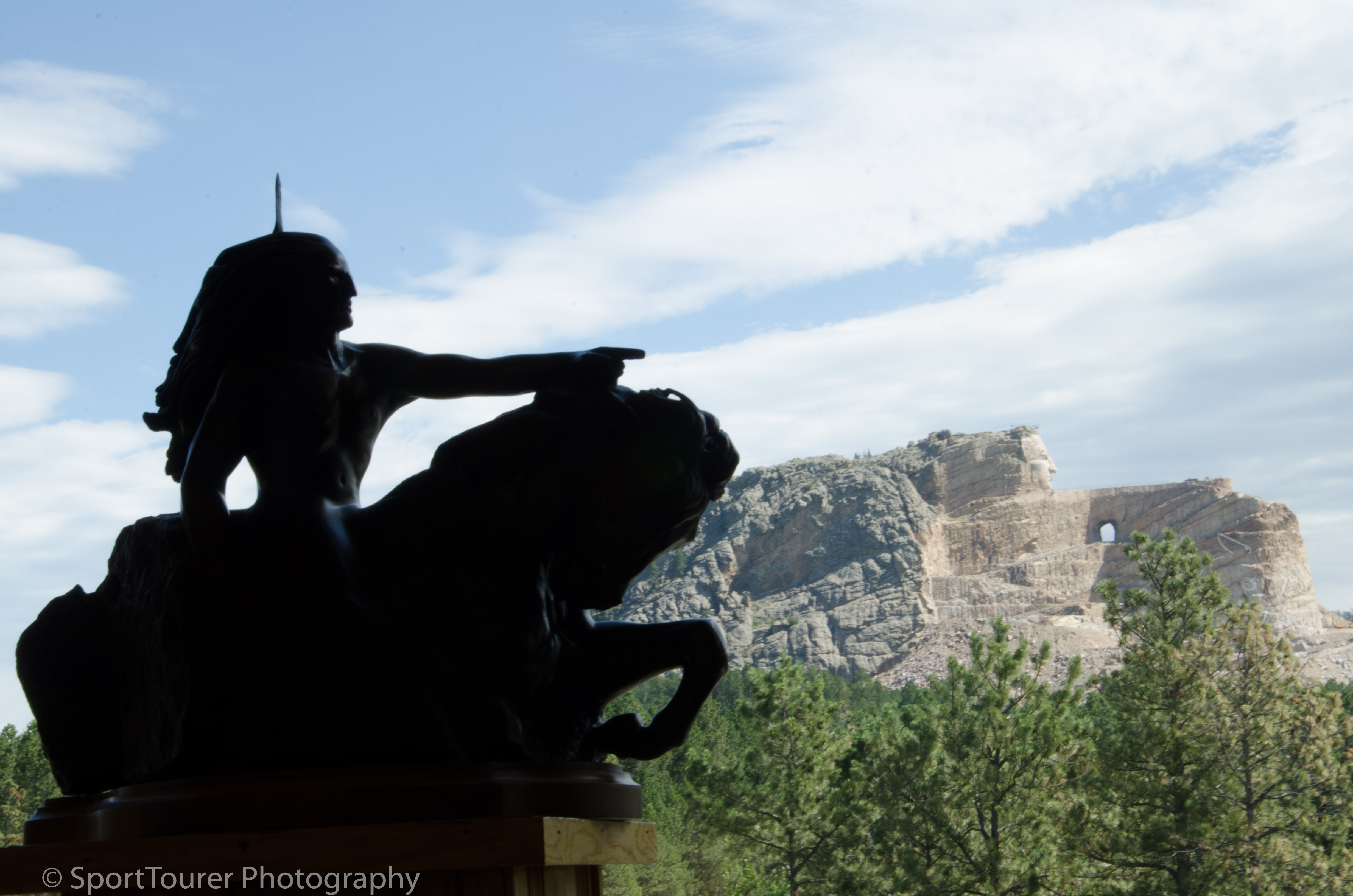  A 1/300th scale of Crazy Horse, silhouetted against the actual, ongoing mountain carving. 