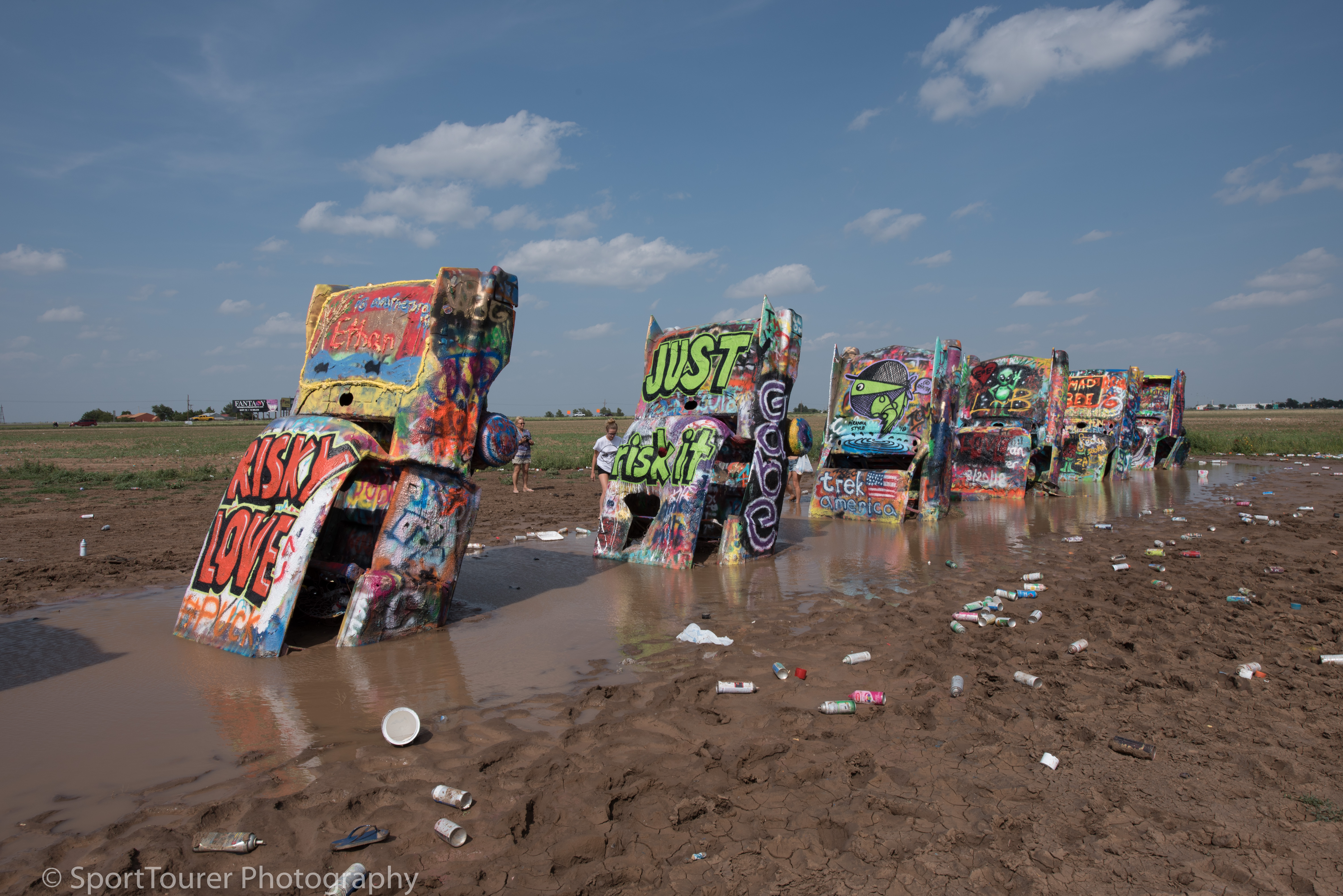  It was so interesting to stick around here at Cadillac Ranch just beyond Amarillo, TX to see the changing artwork being adorned on these automobile fixtures by very talented artists with a keen sense of colors and themes. If you like people-wataching, this is a good place to watch them in their element of interest, doing their thing! 